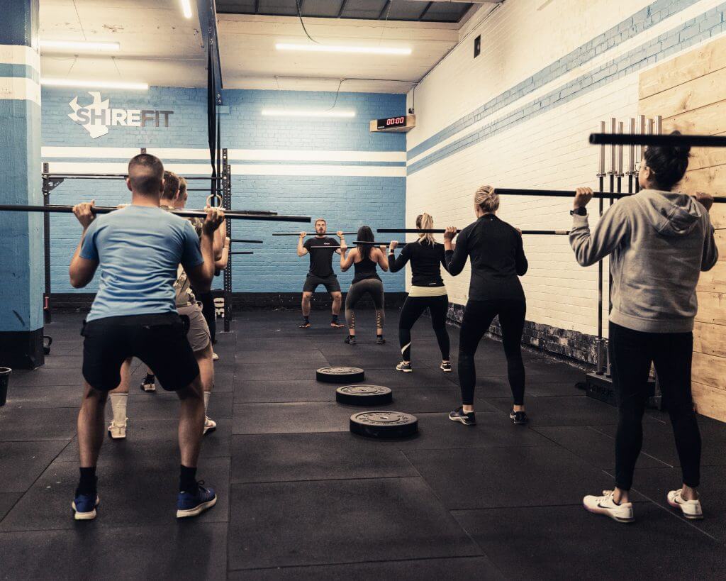 Wall-ball squat in a TRAIN class